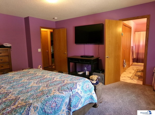 carpeted bedroom featuring a textured ceiling