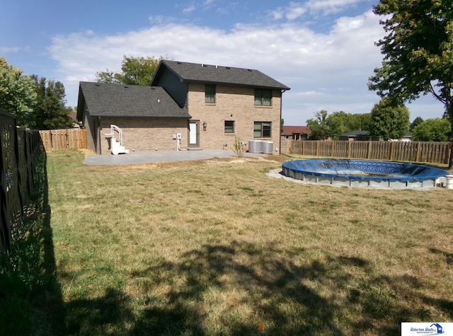 exterior space featuring a patio, cooling unit, and a covered pool