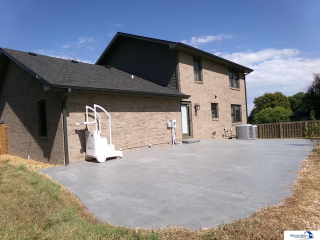 rear view of house featuring a patio and central air condition unit