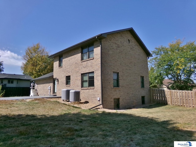 view of property exterior featuring a lawn and cooling unit