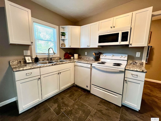 kitchen featuring white appliances, sink, stone countertops, and white cabinets