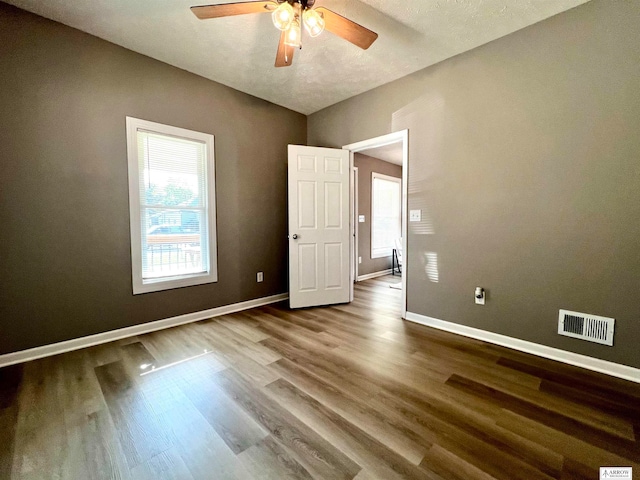 spare room featuring a textured ceiling, ceiling fan, and hardwood / wood-style flooring