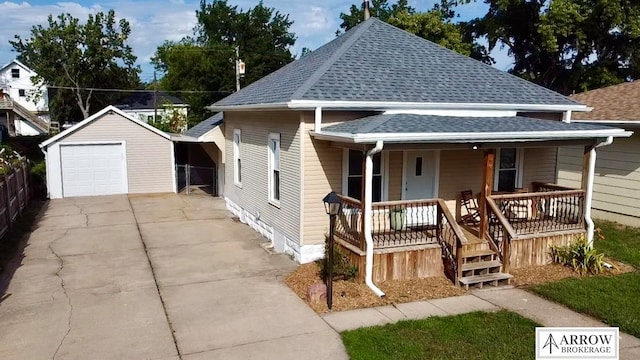 view of front of property with a garage, an outdoor structure, and covered porch