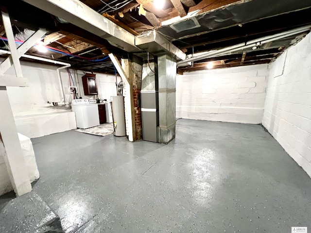 basement featuring heating unit, gas water heater, and independent washer and dryer