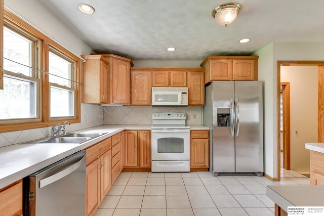 kitchen with light tile patterned floors, decorative backsplash, sink, and stainless steel appliances