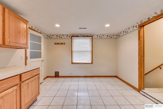 interior space with light brown cabinetry and light tile patterned floors