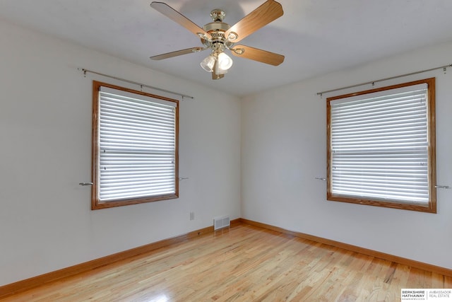 spare room with light wood-type flooring and ceiling fan