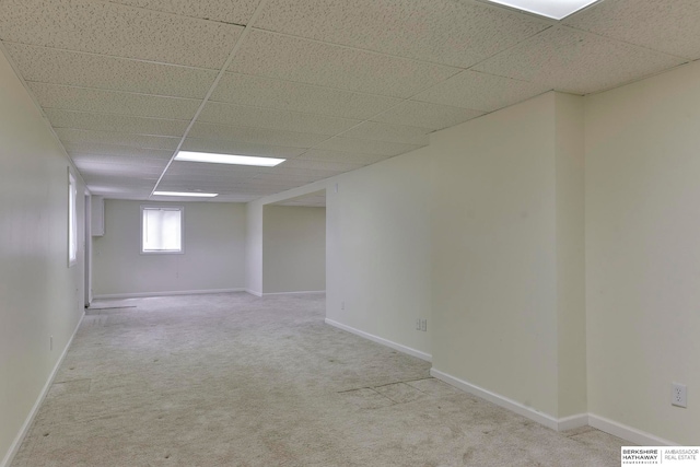 carpeted spare room featuring a paneled ceiling