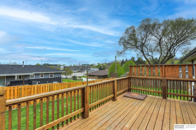 wooden terrace featuring a yard