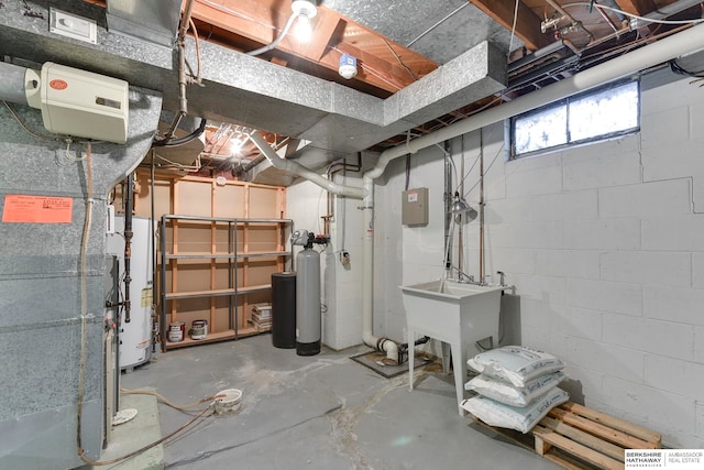 basement featuring gas water heater, heating unit, and sink