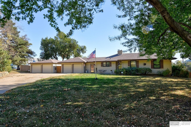 single story home with a garage and a front lawn