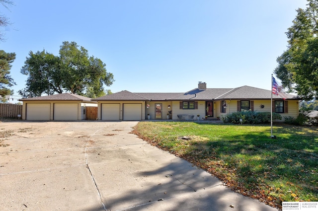 ranch-style home with a garage and a front yard