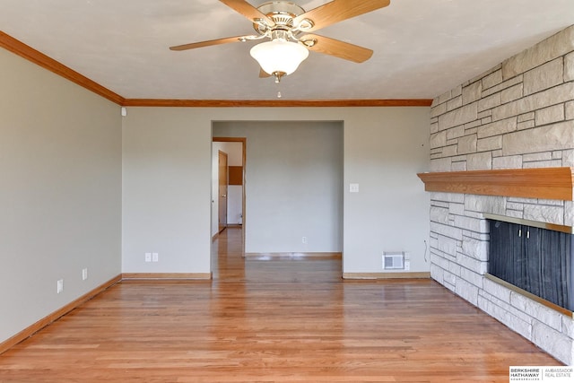 unfurnished living room with wood-type flooring, a fireplace, ornamental molding, and ceiling fan