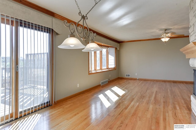 unfurnished dining area with ceiling fan, light hardwood / wood-style floors, and ornamental molding