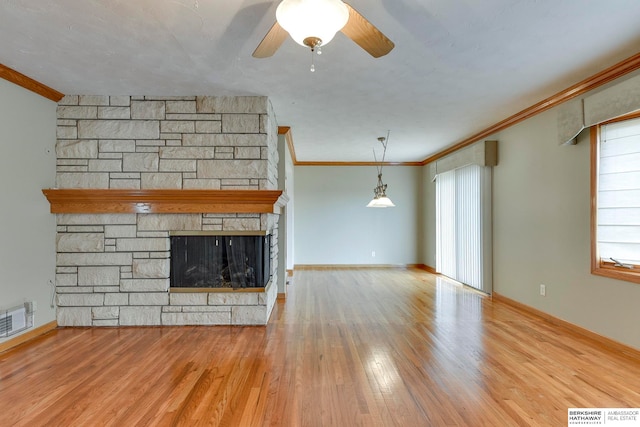 unfurnished living room with ornamental molding, a fireplace, ceiling fan, and light hardwood / wood-style flooring