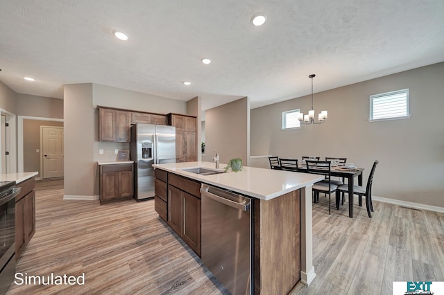8501 Regent Ct, Lincoln, NE 68507 - kitchen featuring an island with sink, appliances with stainless steel finishes, plenty of natural light, and sink