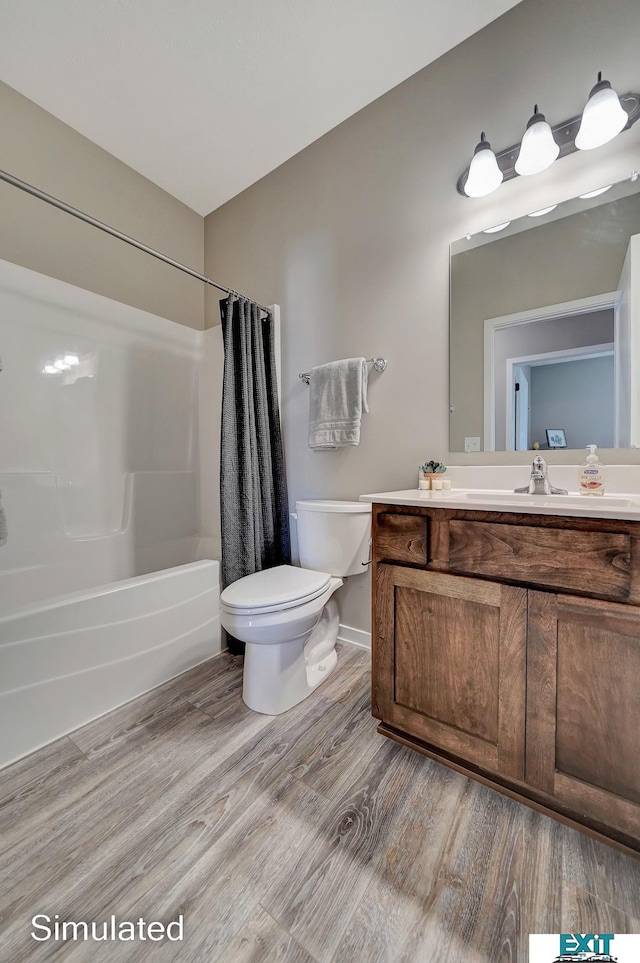 8501 Regent Ct, Lincoln, NE 68507 - full bathroom featuring wood-type flooring, shower / bath combination with curtain, vanity, and toilet
