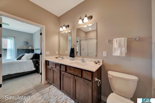 8501 Regent Ct, Lincoln, NE 68507 - bathroom featuring vanity, wood-type flooring, an enclosed shower, and toilet