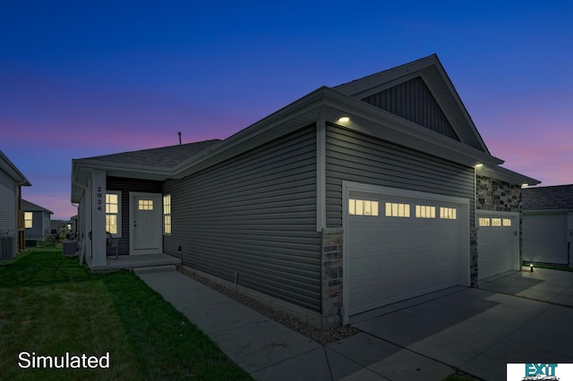 8501 Regent Ct, Lincoln, NE 68507 - view of front facade featuring a yard, a garage, and central air condition unit