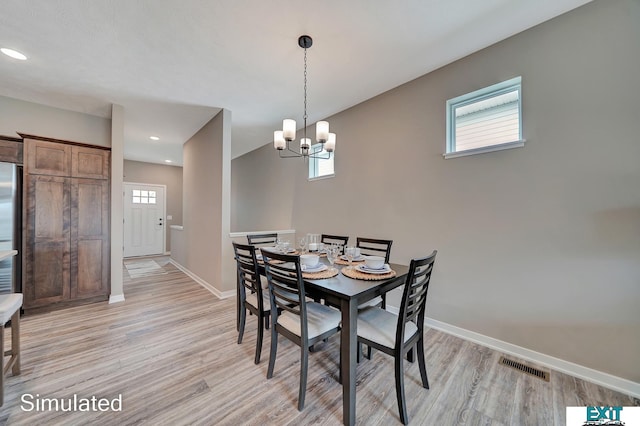 8501 Regent Ct, Lincoln, NE 68507 - dining space with an inviting chandelier, light hardwood / wood-style floors, and a healthy amount of sunlight
