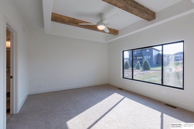 carpeted spare room with ceiling fan and beam ceiling