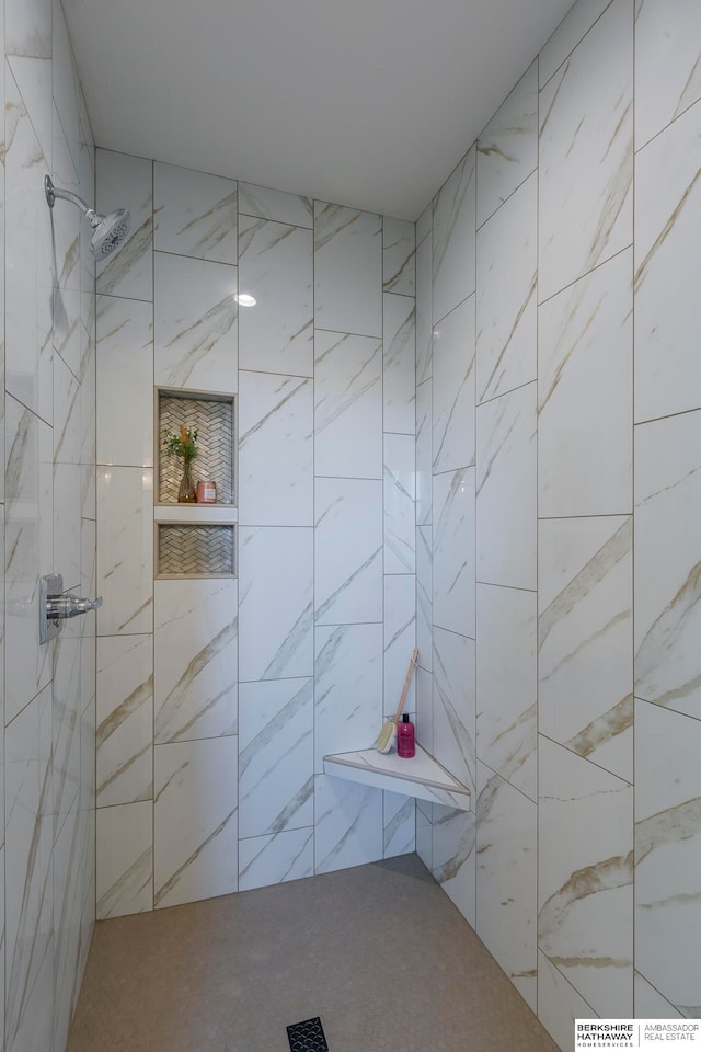 bathroom with tiled shower