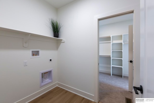 laundry room featuring hookup for a washing machine, hardwood / wood-style floors, and hookup for an electric dryer