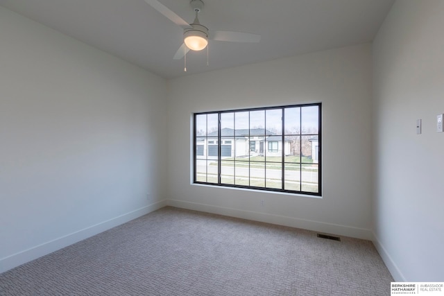 carpeted spare room with ceiling fan