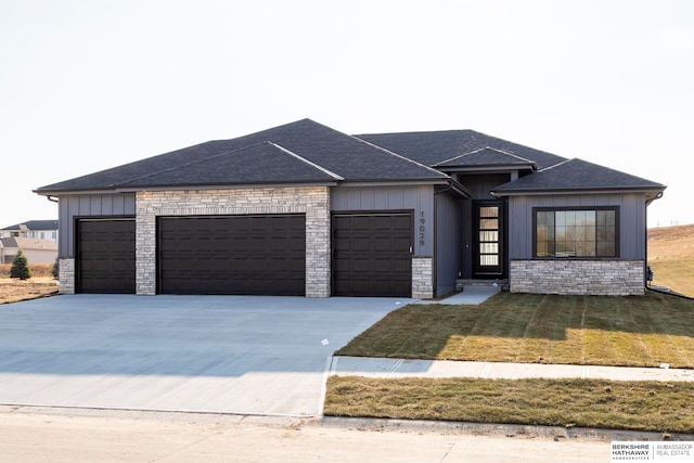 view of front of property with a front yard and a garage