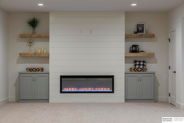 interior details featuring carpet floors and a fireplace