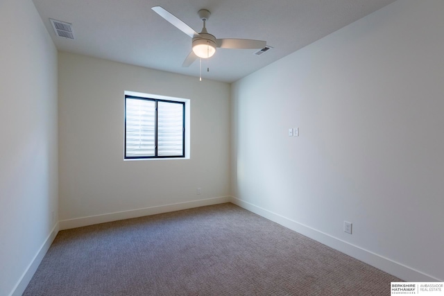 carpeted spare room with ceiling fan