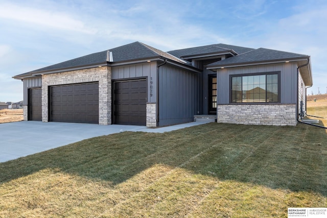 view of front facade with a front yard and a garage