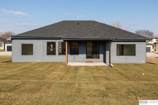 back of house with a patio and a yard