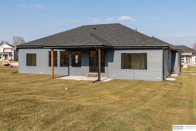 back of house featuring a lawn and a patio