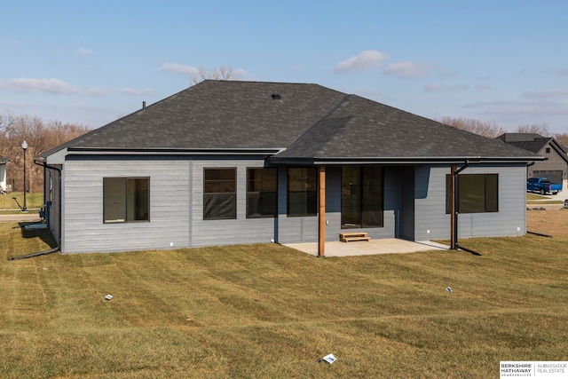 rear view of property with a lawn and a patio