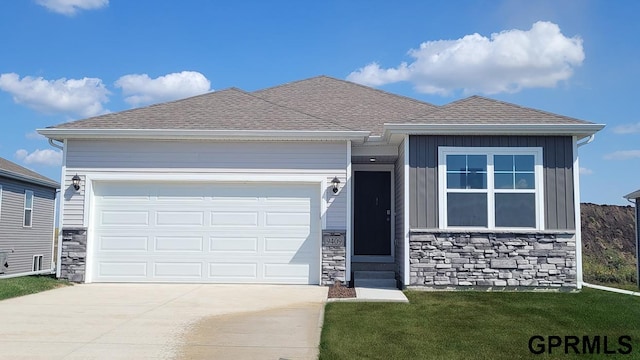 view of front of property featuring stone siding, an attached garage, concrete driveway, and roof with shingles