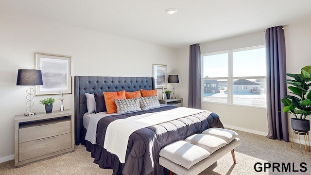 bedroom featuring light colored carpet