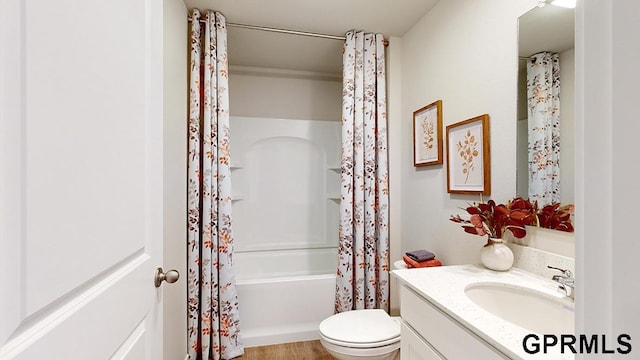 full bathroom featuring shower / tub combo, hardwood / wood-style floors, vanity, and toilet