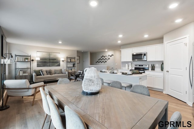 dining space with light wood-type flooring