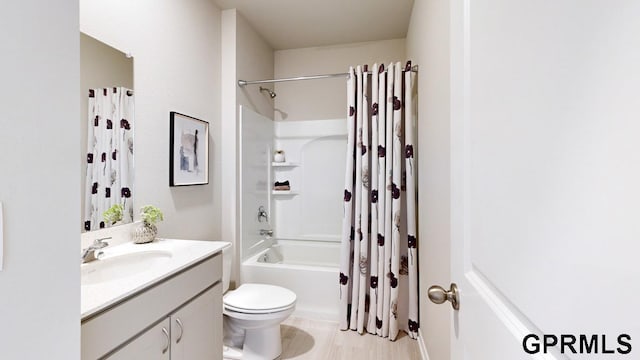 full bathroom featuring vanity, shower / tub combo, and toilet