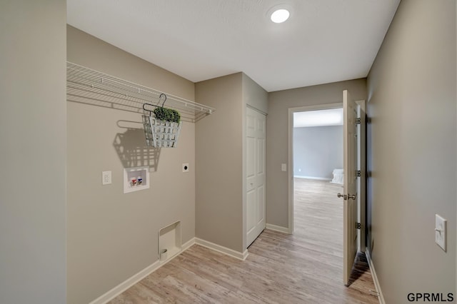 laundry area featuring washer hookup, hookup for an electric dryer, and light hardwood / wood-style flooring