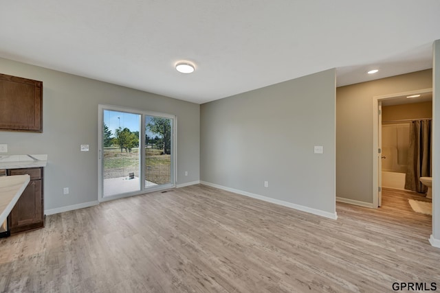 unfurnished living room featuring light wood-type flooring