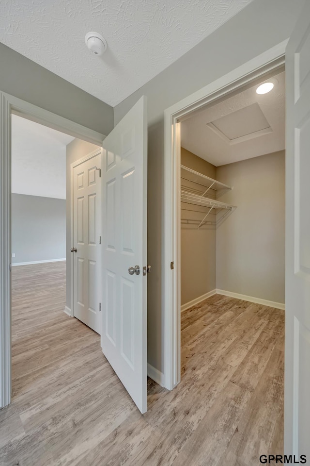 interior space featuring light hardwood / wood-style floors and a textured ceiling