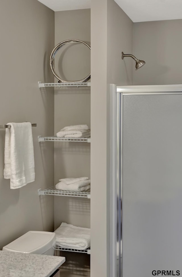 bathroom with a shower with door and vanity