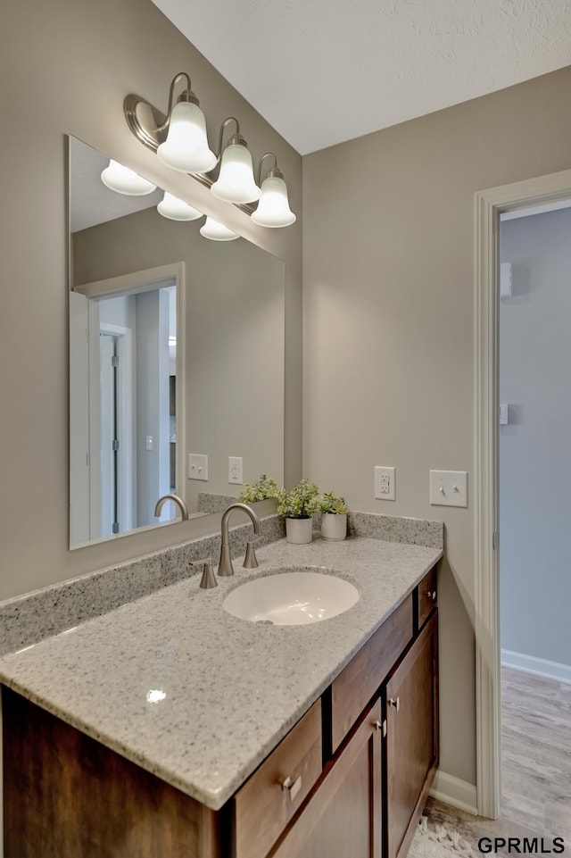 bathroom featuring vanity and hardwood / wood-style flooring