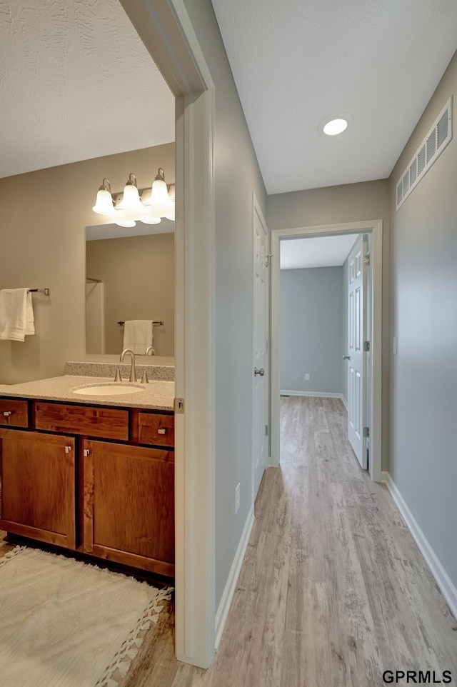 bathroom with vanity and wood-type flooring