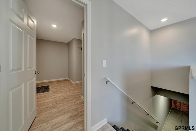 stairs featuring hardwood / wood-style floors