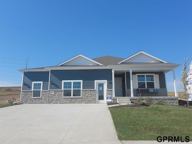 view of front of property with a porch and a front yard