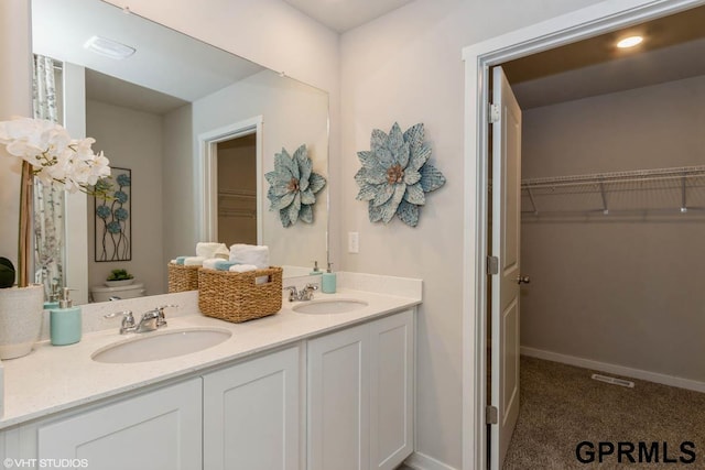 bathroom with vanity and toilet