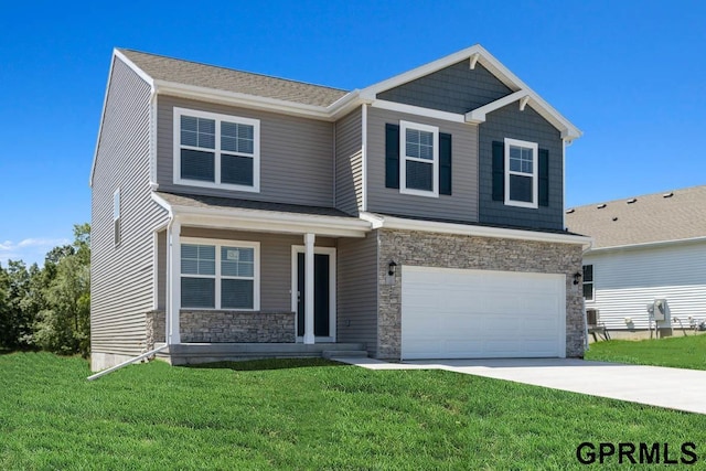 view of front of property featuring a front lawn and a garage